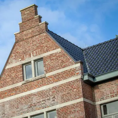 a brick building with a chimney on top of it at Villa Asch in As