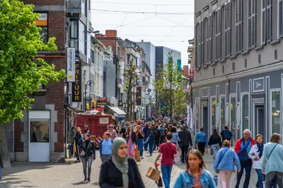 a crowd of people walking down a busy city street at EuroParcs Hoge Kempen in Zutendaal