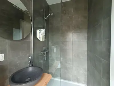 a bathroom with a black sink and a shower at EuroParcs Hoge Kempen in Zutendaal