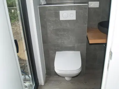 a bathroom with a white toilet and a sink at EuroParcs Hoge Kempen in Zutendaal