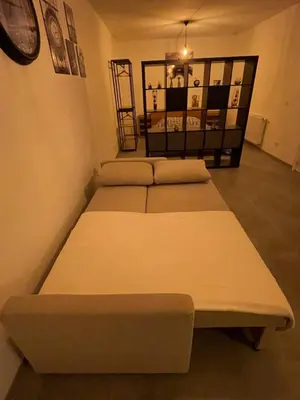a room with three beds and a clock on the wall at Appartement avec extérieur à proximité de Liège in Herstal