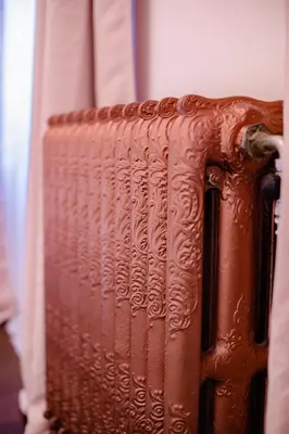 a brown leather suitcase sitting next to a window at GITADIN - Deluxe Suite Valens - Historical Center in Liège
