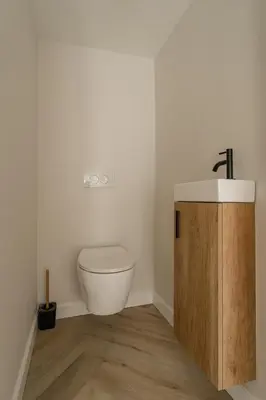 a bathroom with a toilet and a sink at De Dommelhoeve in Peer