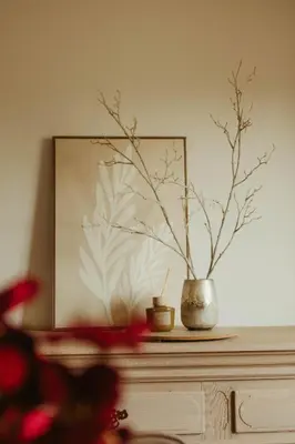 a vase sitting on top of a dresser with a plant at De Dommelhoeve in Peer