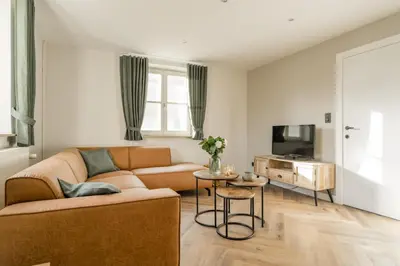 a living room with a couch and a table at De Dommelhoeve in Peer