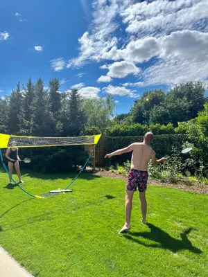 two men standing in a field playing with a net at Vakantiewoning De Winning in Houthalen-Helchteren