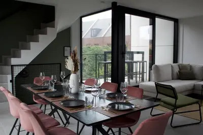 a dining room with a table and chairs at Aan Wal in Rekem