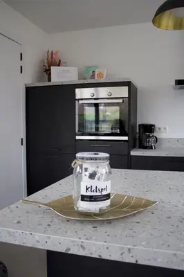 a kitchen counter with a jar on a plate at Aan Wal in Rekem