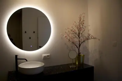 a bathroom with a white sink and a mirror at Aan Wal in Rekem