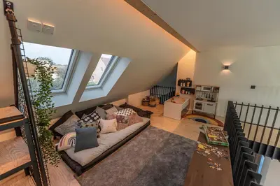 a living room with a couch and some windows at In't Groene Woud in Peer