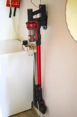 a red vacuum is plugged into a wall at Oasis Verte in La Calamine