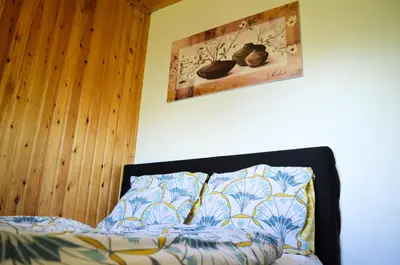 a bedroom with a bed and a picture on the wall at Oasis Verte in La Calamine