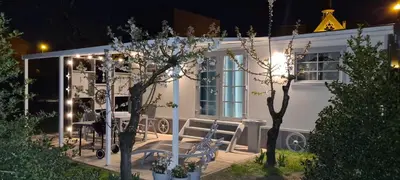 a white house with a table and chairs in front of it at Tijd voor jezelf en elkaar bij Me&We in Zutendaal