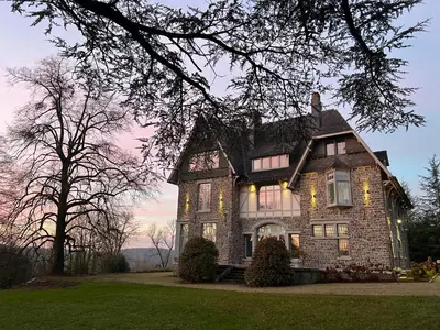 a large brick house with lights on it at Un Toit sur les Monts in Esneux