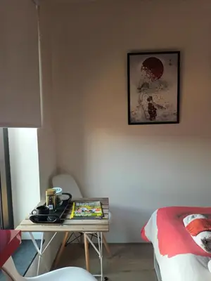 a room with a table and a bed and a table at VERADEMING in Bilzen