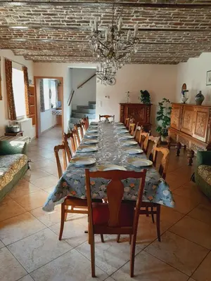 a large dining room with a long table and chairs at Aan het Singelhof - Mirabelle -- 4 sterren -- met sunshower en tuin in Sint-Truiden