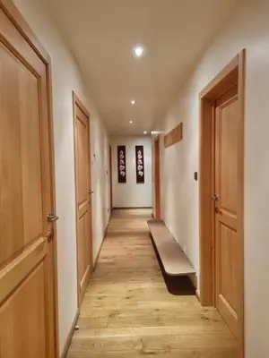 a hallway with wooden floors and two doors at SusBerg-1 & 2 in Pelt