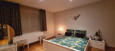 a bedroom with a bed in a room with a window at SusBerg-1 & 2 in Pelt