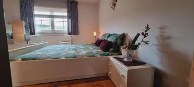 a bedroom with a bed and a sink and a window at SusBerg-1 & 2 in Pelt