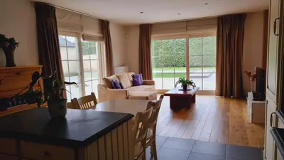 a living room with a couch and a table at SusBerg-1 & 2 in Pelt