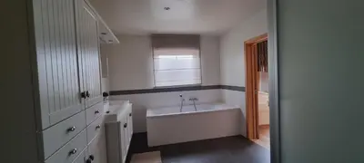 a white bathroom with a tub and a window at SusBerg-1 & 2 in Pelt