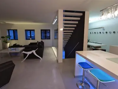 a living room with a couch and a staircase at B&B Bianero in Peer