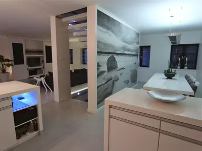 a kitchen and living room with a large painting on the wall at B&B Bianero in Peer
