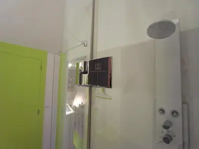 a shower with a glass door in a bathroom at B&B Bianero in Peer