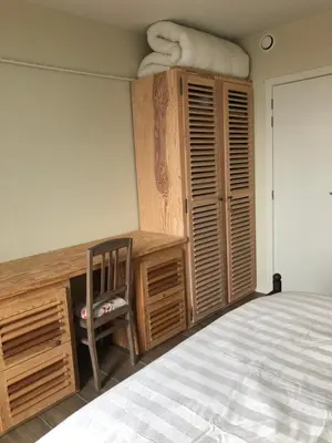 a bedroom with a bed and a desk and a chair at Residentie Zeezicht in Eksel