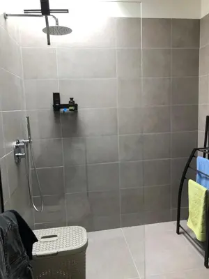 a bathroom with a shower with a glass door at Residentie Zeezicht in Eksel