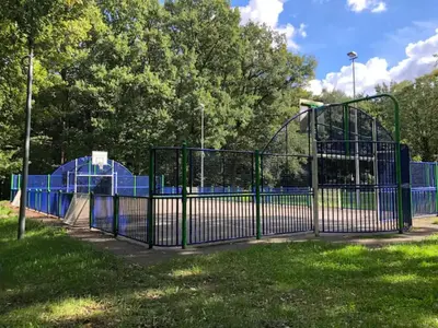 an open gate at a park with a playground at De Bosdreef - Hengelhoef - duplex met verwarmd openluchtzwembad in Houthalen-Helchteren