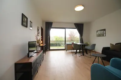 a living room with a couch and a tv at Oscappart in Eupen