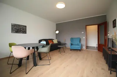 a living room with a table and chairs and a couch at Oscappart in Eupen