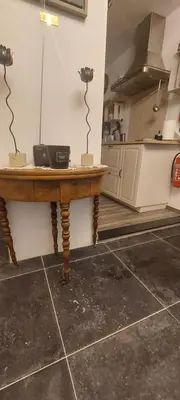 a kitchen with a wooden table in a kitchen at 'T boshuisje in Oudsbergen