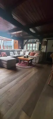 a living room with a couch and a table at 'T boshuisje in Oudsbergen