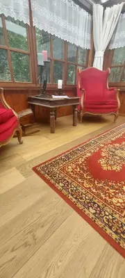 a living room with a red couch and a table at 'T boshuisje in Oudsbergen