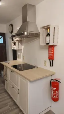 a kitchen with a sink and a stove at 'T boshuisje in Oudsbergen