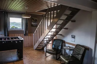 a living room with a staircase and a pool table at Ô Macra House - Aubel, Pays de Herve in Aubel
