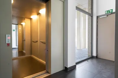 a hallway with a mirror in a building at Saint Pablo Design Apt I 2BR, Free Parking, Stunning View & Large Terrace in Hasselt