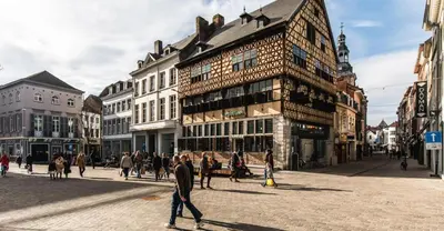 a group of people walking on a street in a city at Saint Pablo Design Apt I 2BR, Free Parking, Stunning View & Large Terrace in Hasselt