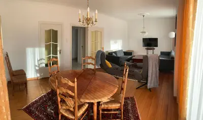 a living room with a wooden table and a couch at De Lelie in Achel