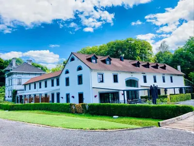 a large white house with a brown roof at De Molenhoeve B&B in Voeren