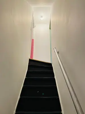 a staircase with a red and white stripe at Bien-être-Au-calme et parking gratuit in Seraing