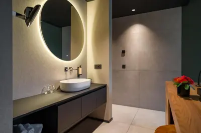 a bathroom with a sink and a mirror at Aux Etangs - Hôtel in Battice