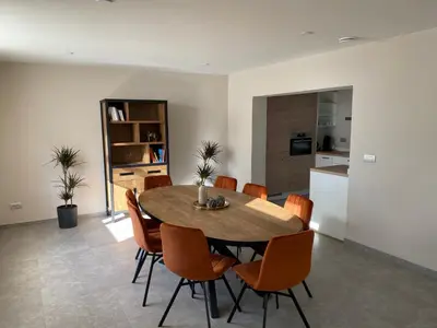a kitchen and dining room with a table and chairs at De oude es in Bocholt