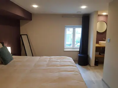 a bedroom with a large bed and a window at De oude es in Bocholt