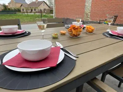 a wooden table with a bowl and a plate of food at De oude es in Bocholt