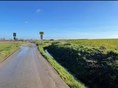 a road in the middle of a field at Het Damhert in Kortenaken