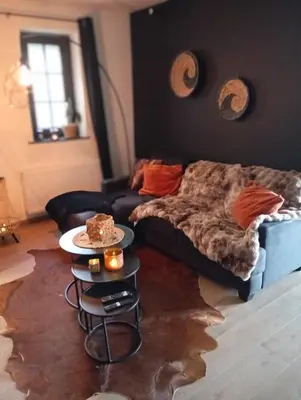 a living room with a bed and a table at Suite Tino in Verviers