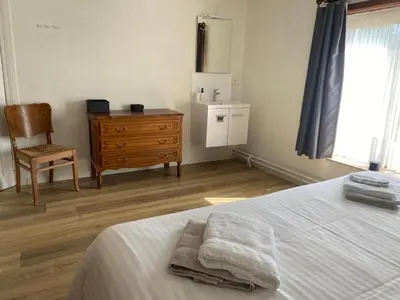 a bedroom with a bed and a chair and a dresser at Vakantiewoning Wurfeldermolen in Maaseik